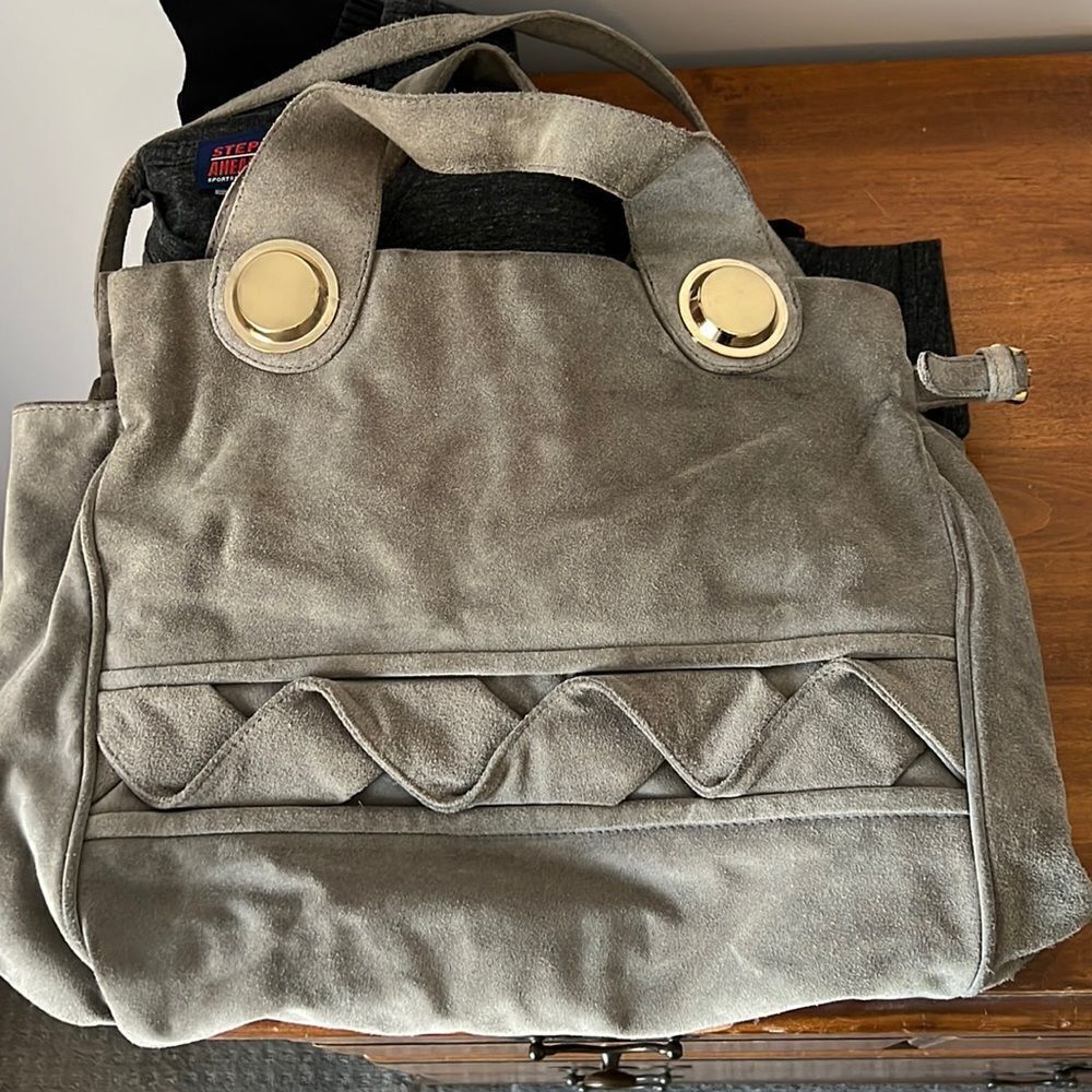 Gustto suede handbag with gold accents. Gray